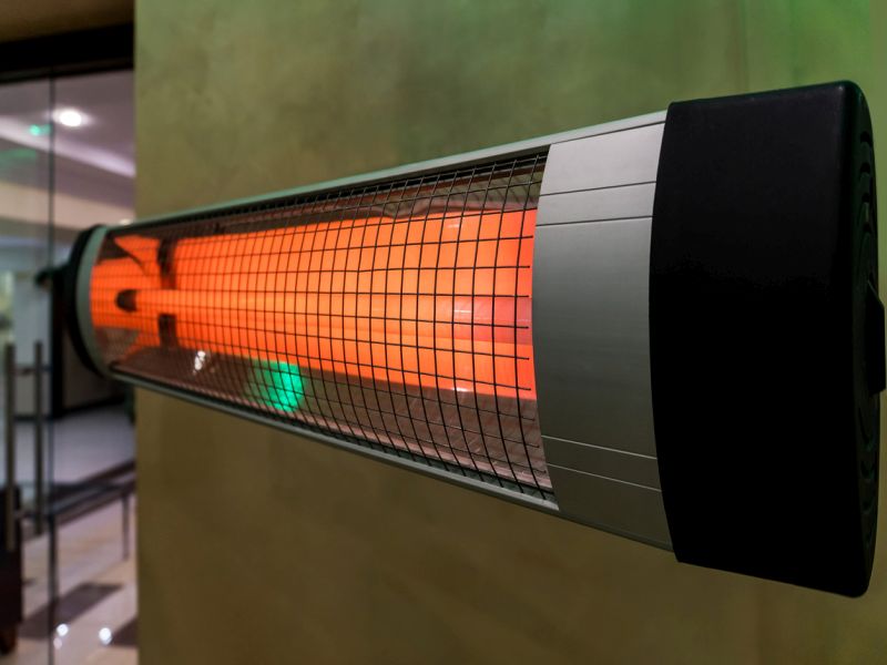 heater electric on the cold floor winter device. Heating the room in the cold winter. Warm bright halogen heater.